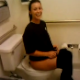 A pretty girl is video-recorded shitting while sitting on a toilet in a public restroom by her pretty friend. Pooping sounds are subtle, but completely audible. The girls react immediately to the bad smell. See video 3396 to watch the other girl pooping!
